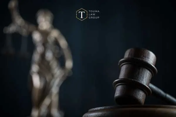 a gavel and statue of justice in front of a black background